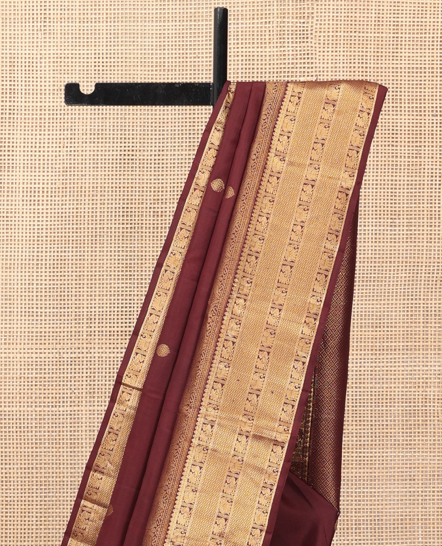 Brown Kanchipuram Silk Saree, Adorned with Zari Buttas, a Zari Border of Iruthalai Pakshi, Thilakam, Kathir, Mayil, Yaanai, and Mayil Kann Designs, Jaal Pallu, and a Matching Blouse