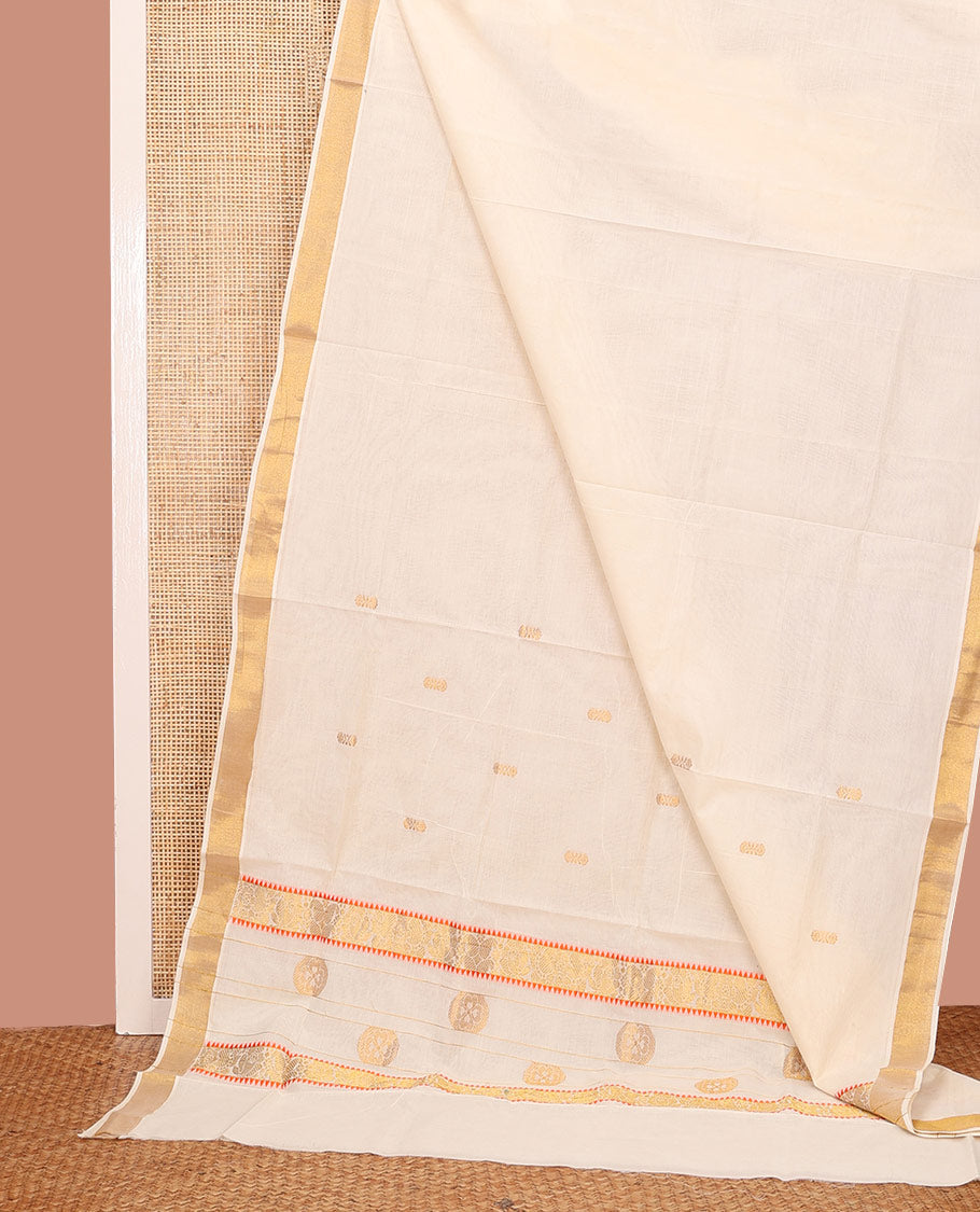 Cream Kerala Saree, Adorned with Zari Buttas on its Body, Subtly Sparkled Bavanji Border, Pallu Features Chakram Motifs, and Paired with a Matching Blouse