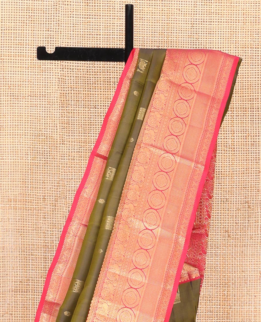 Green Vasundhara Silk Saree, Elevated with Zari Buttas on Its Body, Complemented by a Contrast Border of Thilakam Mokku, Muthu, Ara Maadam, Paisa, Kodi Visiry, and Annam Chakram Designs, Grandly Zari-Woven Pallu, and Paired with a Contrast Blouse
