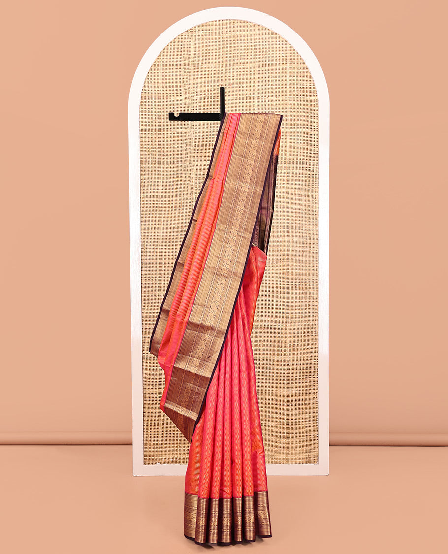 Orange Vasundhara Silk Saree, Gleamed Up with Stripes All Over Its Body, Complemented by a Contrast Border of Thilakam Mokku, Kathir, Vanki, Laddu Kamalam, and Mayil Designs, Intricately Designed Pallu, and Paired with a Contrast Blouse