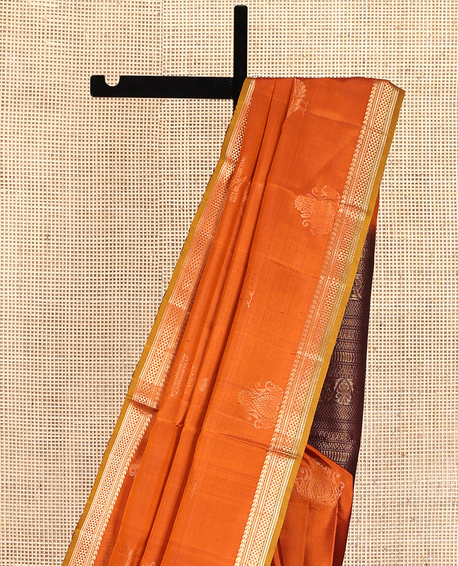 Orange Mayuri Soft Silk Saree, Accentuated with Zari Buttas All Over Its Body, Highlighted by Zari Border of Manga Mokku, and Ara Maadam Designs, and Paired with a Contrast Geometric Patterned Pallu and Paired with a Contrast Blouse