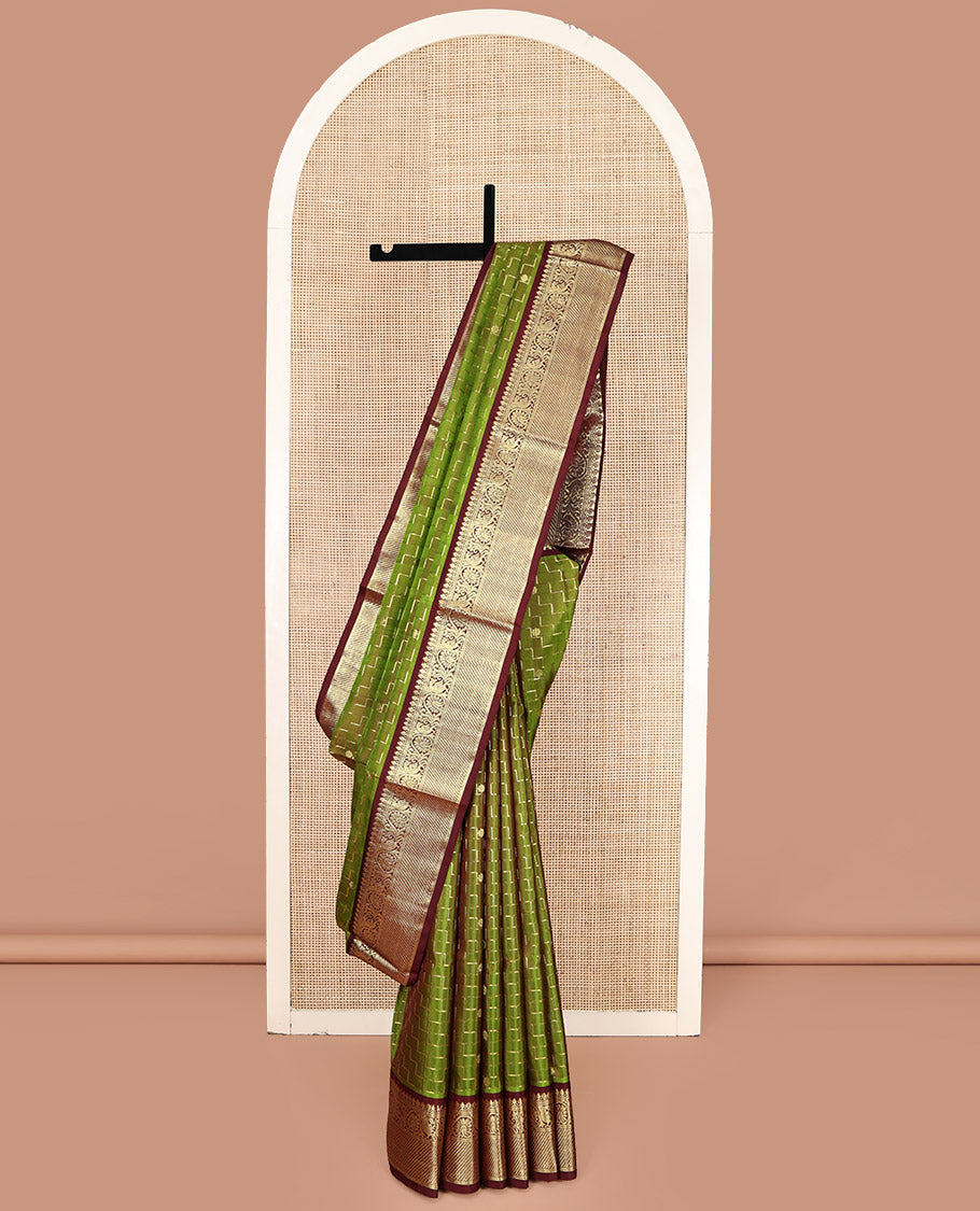 Green Venkatagiri Silk Saree, Delicately Woven with Zari Butta and Chevron Stripes All Over Its Body, Complemented by a Contrast Traditional Zari Border, Pallu of Ogee Designs, and Paired with a Contrast Blouse