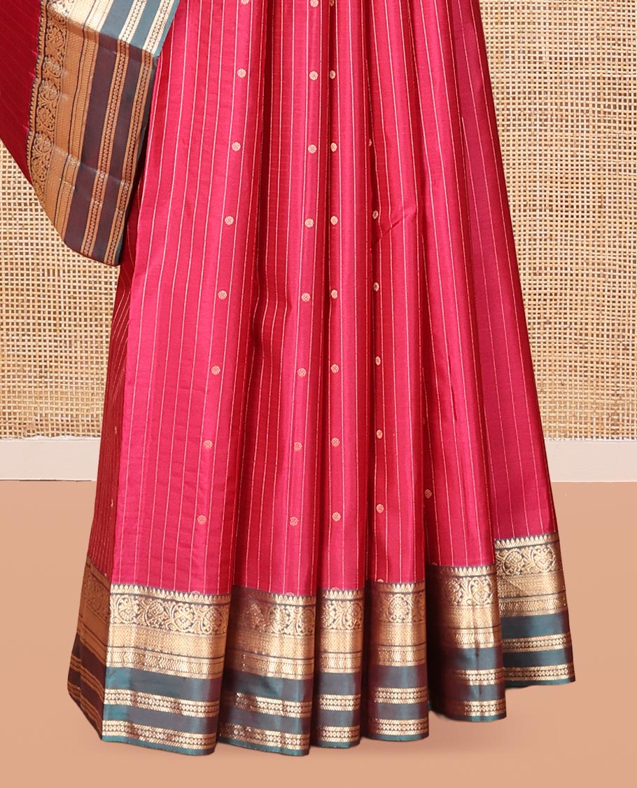 Red Vasundhara Silk Saree, Spotlighted with Zari Buttas and Stripes, a Contrast Rettai Pettu Border of Thilakam, Kamalam, Banaras, and Muthu Designs, Jaal Pallu, and Contrast Blouse