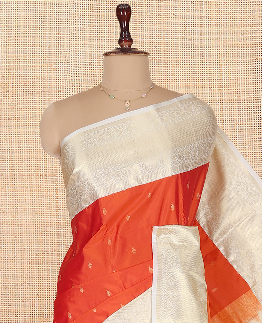Rust Orange Budget Silk Saree, Gleamed Up with Zari Buttas on Its Body, Complemented by a Contrast Traditional Zari Design Border, Grandly Decked Up Pallu, and Paired with a Contrast Blouse