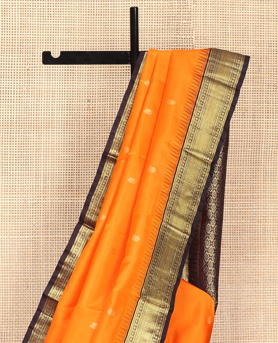 Orange Vasundhara Silk Saree, Artfully Woven with Mayil Buttas All Over Its Body, Complemented by Contrast Border Featuring Thazampoo Rekku, Muthu, Lavangam, and Mayil Kann Designs, a Grand Pallu of Jaal Designs, and Paired with a Contrast Blouse