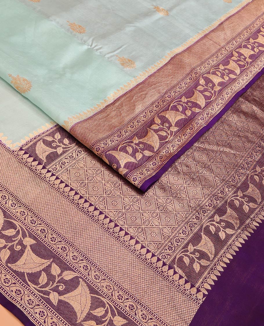 Baby Blue Raw Mango Silk Saree Subtly Sparked with Buttas, Complemented by a Contrast Traditional Zari-Designed Border, Featuring a Zari-Elevated Jaal-Designed Pallu, Paired with a Contrast Blouse