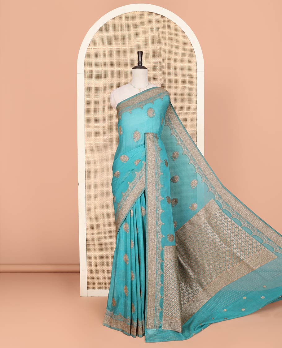 Blue Fancy Georgette Saree Sparsely Sparkled with Zari Buttas, Hazily Zari Woven Border of Scallop Designs, Zari Woven Pallu of Ogee Patterns, and Paired with a Matching Blouse