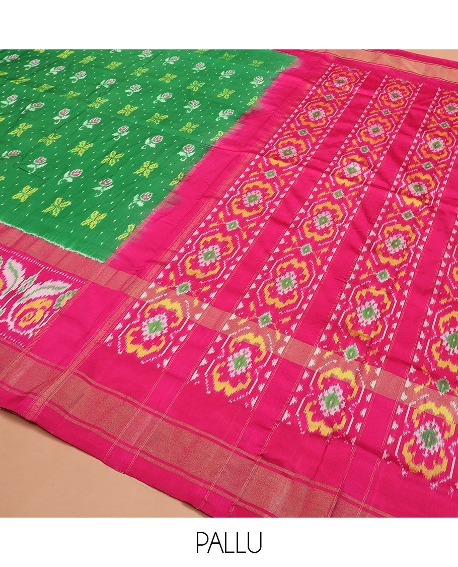Green Ikkat silk saree features floral Ikkat buttas, highlighted with a contrast Ikkat woven border, a hazily woven Ikkat patterned pallu, and a contrast blouse