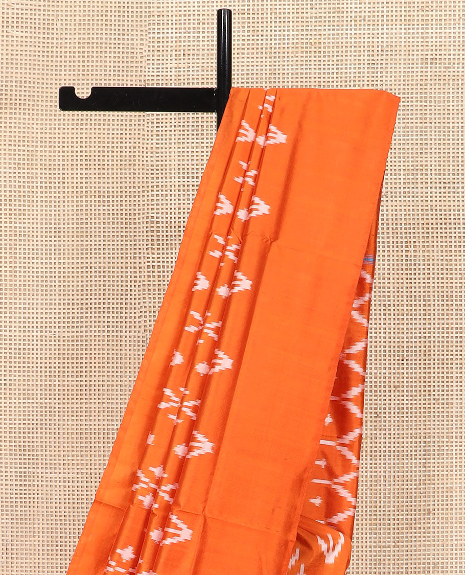 Orange Ikkat Silk Saree Decked with Ikkat Buttas, Featuring a Subtle Plain Border, Complemented by a Pallu Woven in an Ogee Pattern with Ikkat Texture
