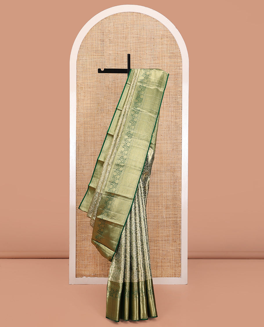 Green Kanchipuram Tissue Silk Saree, Majestically Detailed with Jacquard Designs on Its Body, Highlighted by a Zari Border of Jaal, and Floral Designs, Intricately Designed Pallu, and Paired with a Matching Blouse