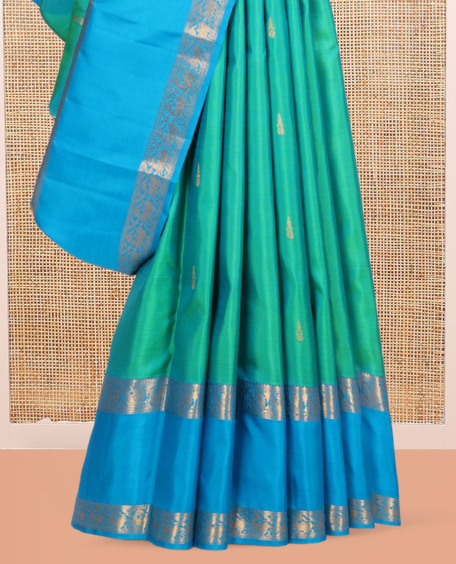Green Kanchipuram Silk Saree, Ornamented with Zari Buttas, Complemented by Contrast Rettai Pettu Border of Rekku, Muthu, and Mayil Designs, Jaal Pallu, and Contrast Blouse