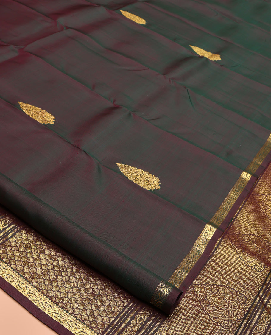 Brown Kanchipuram Silk Saree, Elevated with Zari Buttas All Over Its Body, Highlighted by Zari Piping Border, Grand Scallop Design Pallu, and Paired with a Matching Blouse