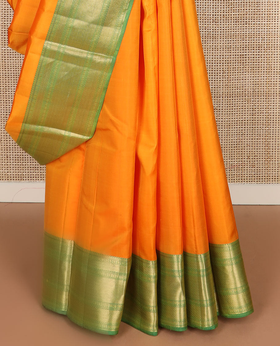 Orange plain Kanchipuram silk saree, contrast border of rudraksham, mayil kann & zari stripes & jaal pallu
