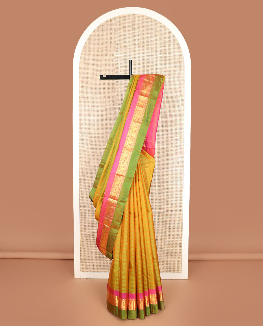 Green striped Kanchipuram silk saree, contrast border of rekku, kodi manga and mayil designs, and zari striped pallu