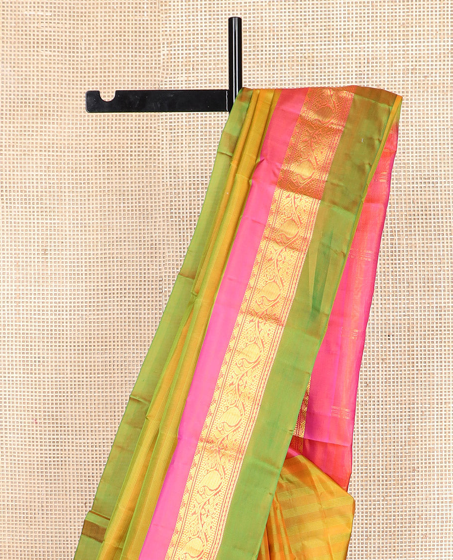 Green striped Kanchipuram silk saree, contrast border of rekku, kodi manga and mayil designs, and zari striped pallu
