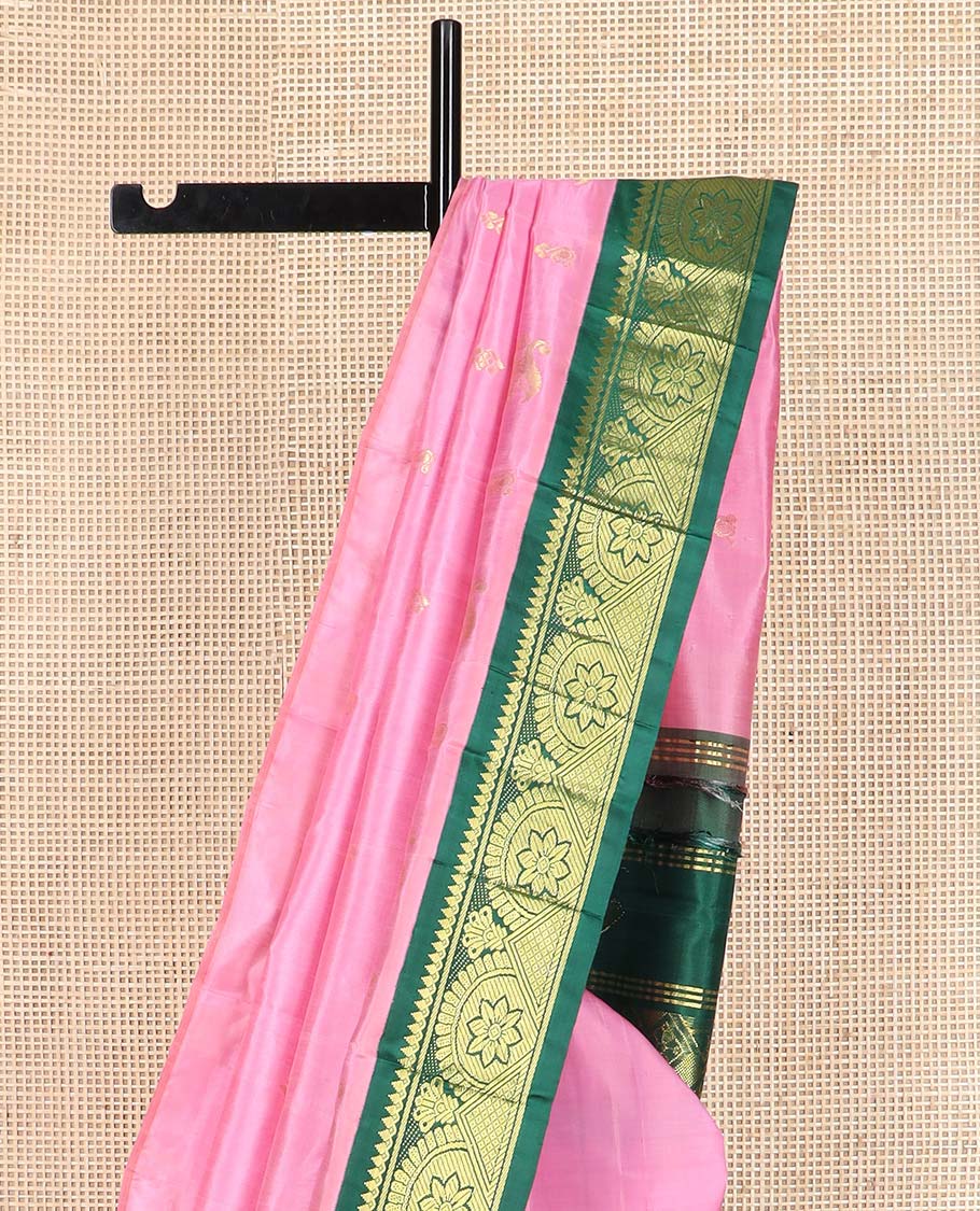 Pink zari buttas Kanchipuram silk saree, contrast one-sided border of thilakam mokku, chakram, and mayil kann, and floral-paisley pallu