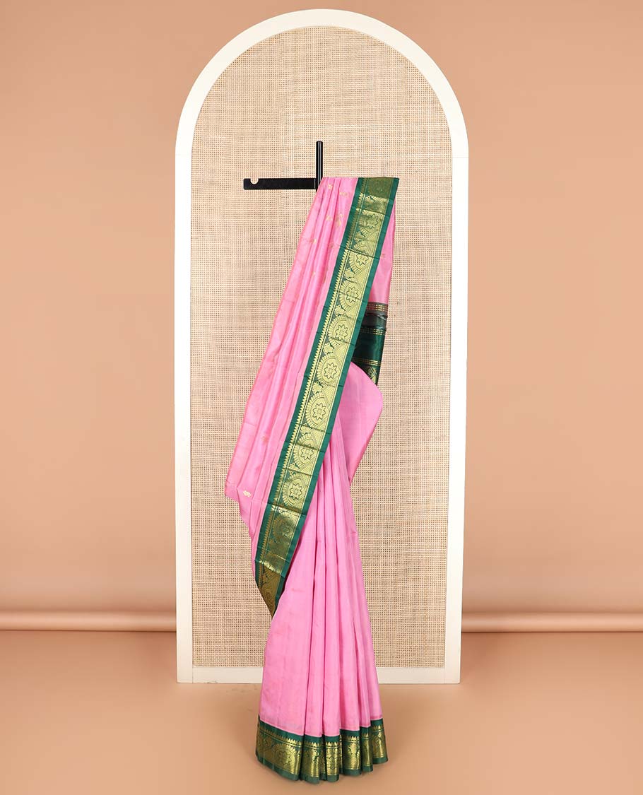 Pink zari buttas Kanchipuram silk saree, contrast one-sided border of thilakam mokku, chakram, and mayil kann, and floral-paisley pallu