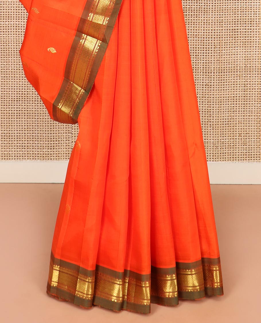Orange Kanchipuram Silk Saree Mesmerized with Zari Buttas All Over Its Body, Complemented by a Contrast One-Sided Border of Rekku, Banaras, and Mayil Kann Designs, Pallu of Zari Stripes, and Comes Without a Blouse