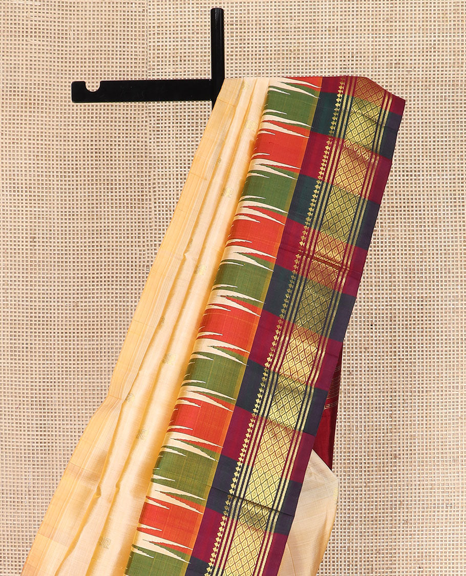 Sandal Kanchipuram Silk Saree Sparsely Sparkled with Zari Buttas, Complemented by Contrast One-Sided Thazampoo Rekku Border of Paneer Sombu, Banaras, and Mayil Kann Designs, Grandly Woven Pallu Steeped with Floral Designs, and Comes Without a Blouse