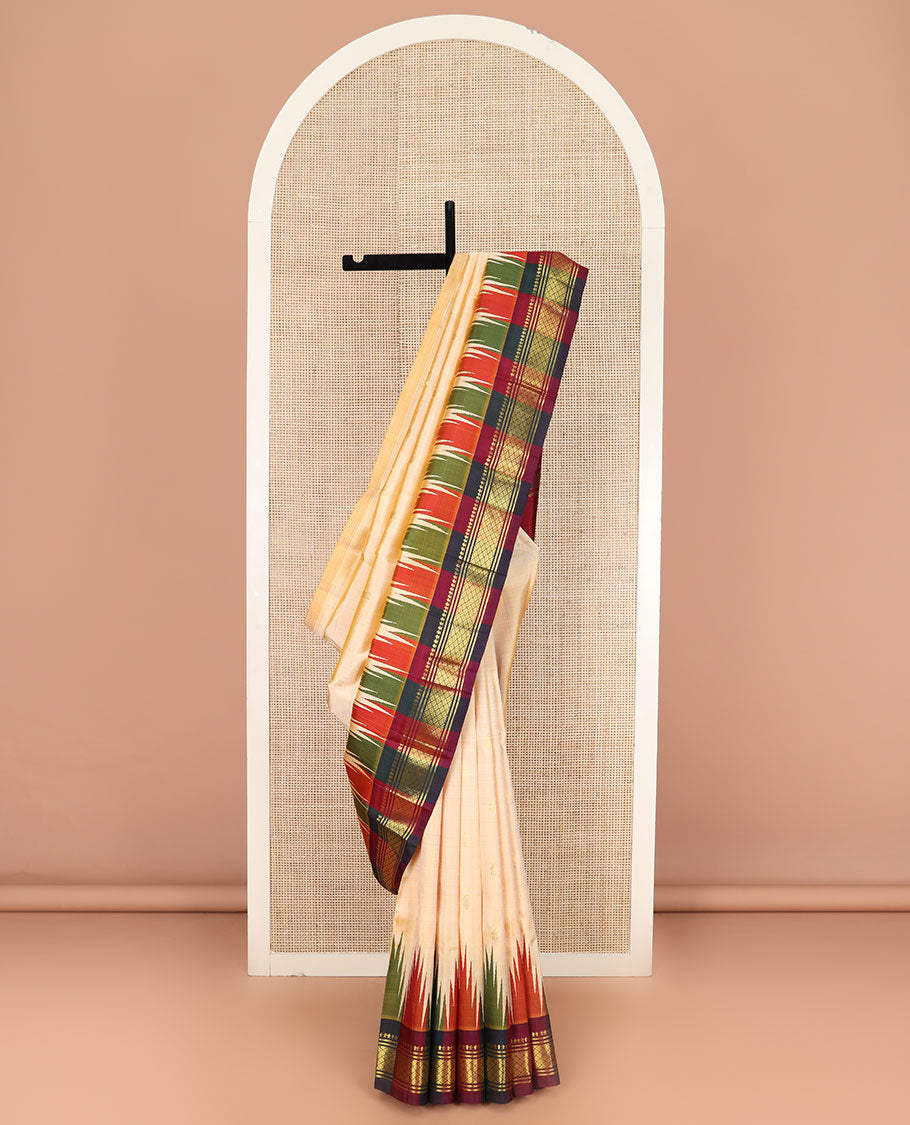 Sandal Kanchipuram Silk Saree Sparsely Sparkled with Zari Buttas, Complemented by Contrast One-Sided Thazampoo Rekku Border of Paneer Sombu, Banaras, and Mayil Kann Designs, Grandly Woven Pallu Steeped with Floral Designs, and Comes Without a Blouse