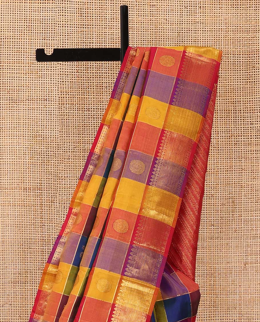 Multi-color paalum pazhamum checked annam chakram buttas Kanchipuram silk saree, zari border of thilakam mokku, rudraksham and vanki designs, and leaf vine pallu