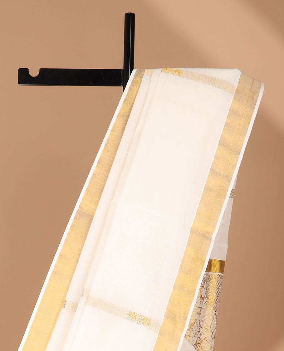 Cream kerala saree adorned with zari designs, zari border & pallu of intricate zari designs