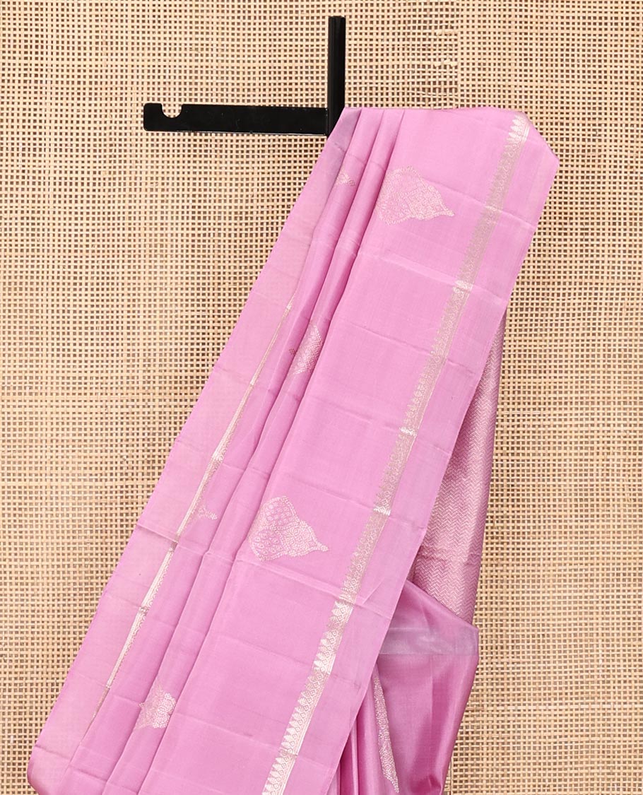 Pink Mayuri Soft Silk Saree, Embellished with Buttas All Over Its Body, Subtly Sparkled Kal Erangina Border of Thilakam Mokku Designs, Intricately Woven Pallu of Chevron Designs, and Paired with a Matching Blouse