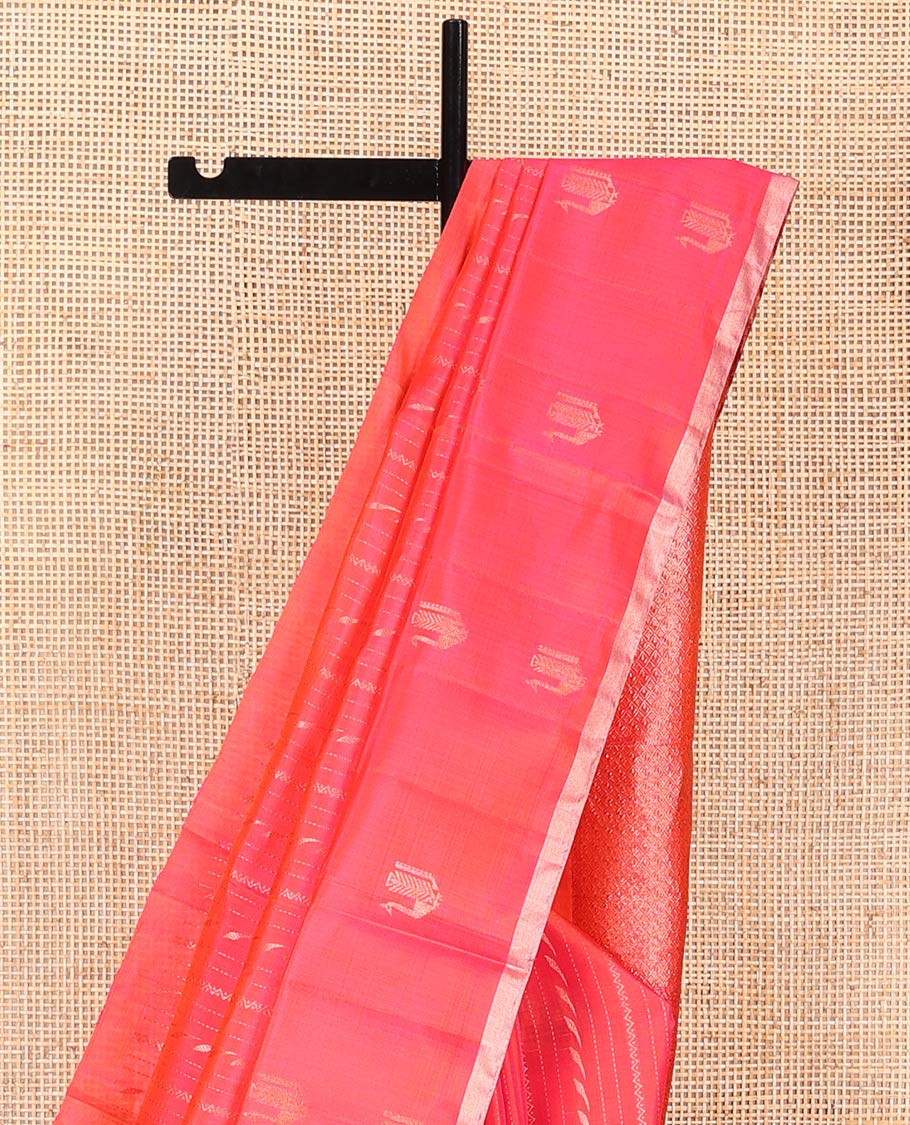 Orange Mayuri Soft Silk Saree, Mesmerized with Neli, and Muthu Designs All Over Its Body, Highlighted by Zari Border of Peacock Designs, Boldly Accentuated Jaal Pallu, and Paired with a Matching Blouse
