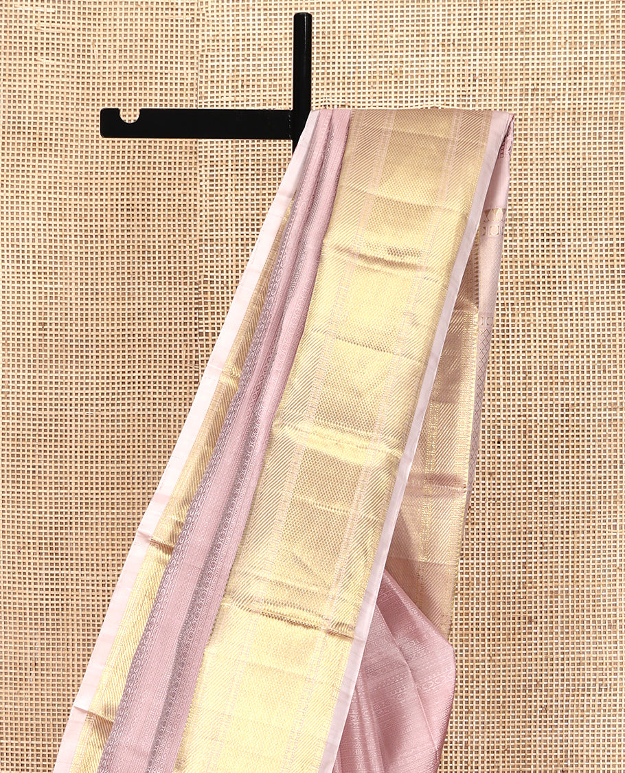Baby Pink Geometric Embossed Parampara Silk Saree, Gleamed up with Zari Border of Rekku, Poun, Mayil Kann, and Zari Stripes, and Grand Jaal Pallu and Paired with a Matching Blouse