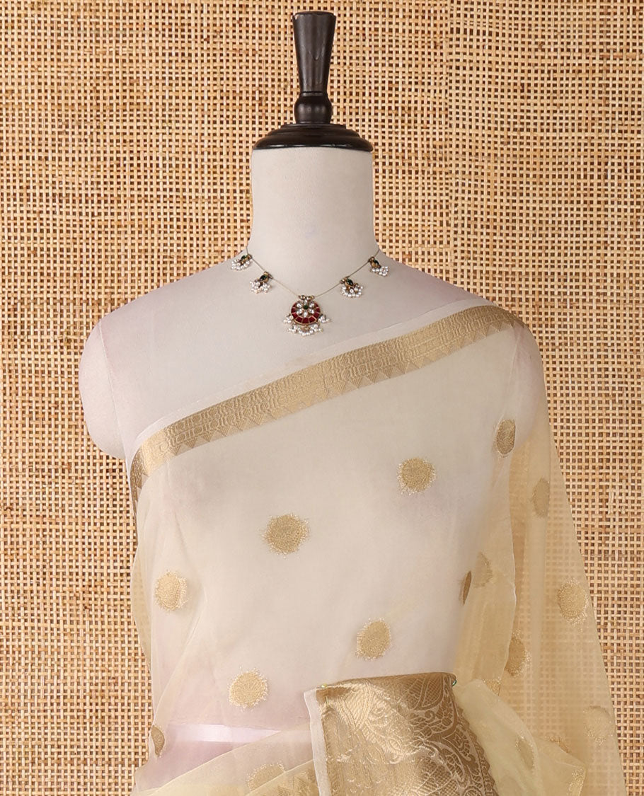 Cream semi-organza saree with zari buttas, zari border of temple & floral creeper designs, zari design pallu & running blouse
