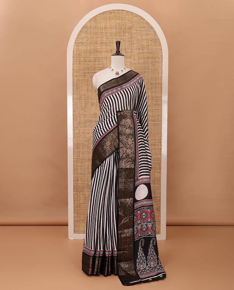 Black stripes printed soft dola saree,contrast floral creeper design zari border,Ajrakh-print pallu & blouse of floral butta & zari design