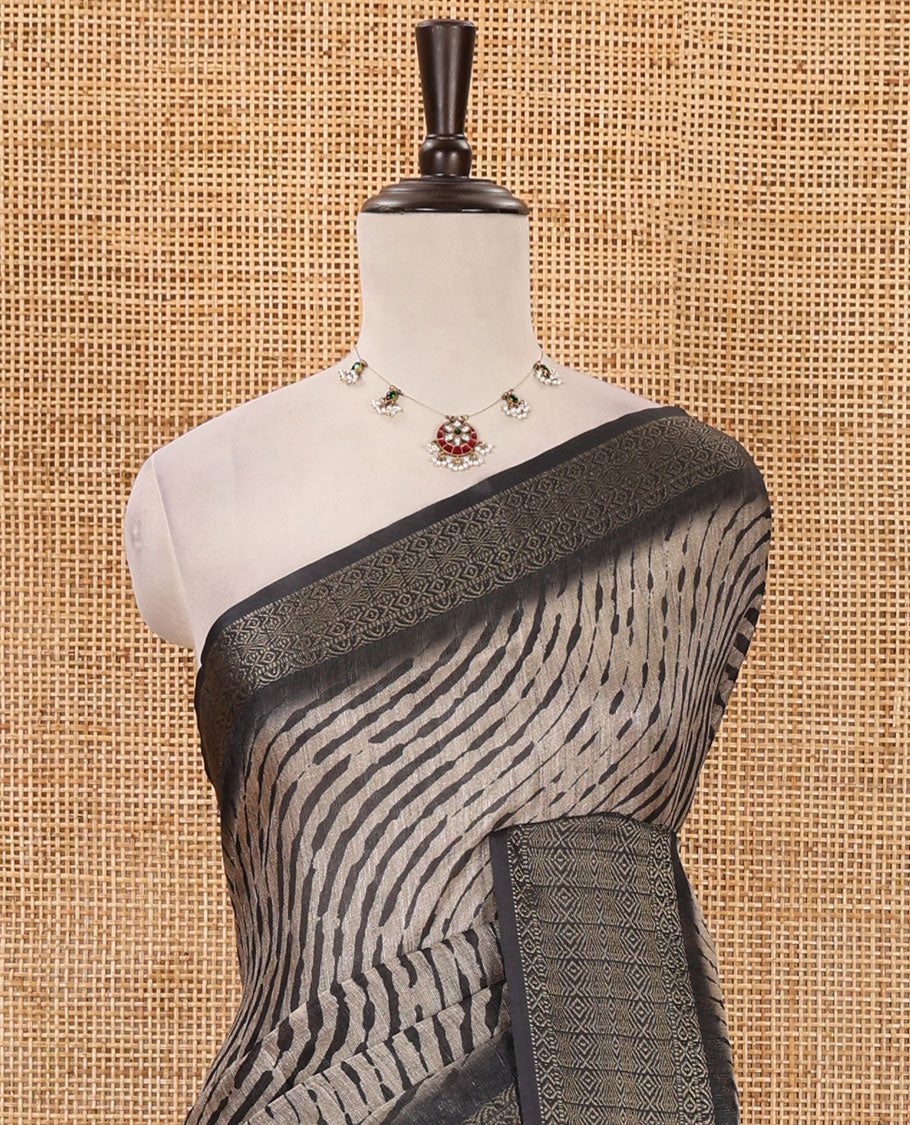 Chikku lehariya stripes printed semi-jute saree, contrast geometric zari border, printed pallu, & black blouse of print & zari work