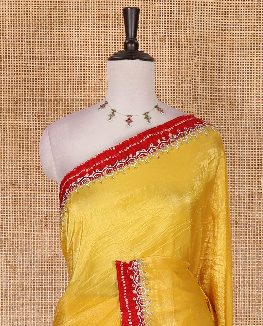 Yellow bandhani mango jhumka patch embroidered crunchy crushed saree, contrast border, and pallu of Swarovski stonework, bandhani dots, and bandhani printed blouse