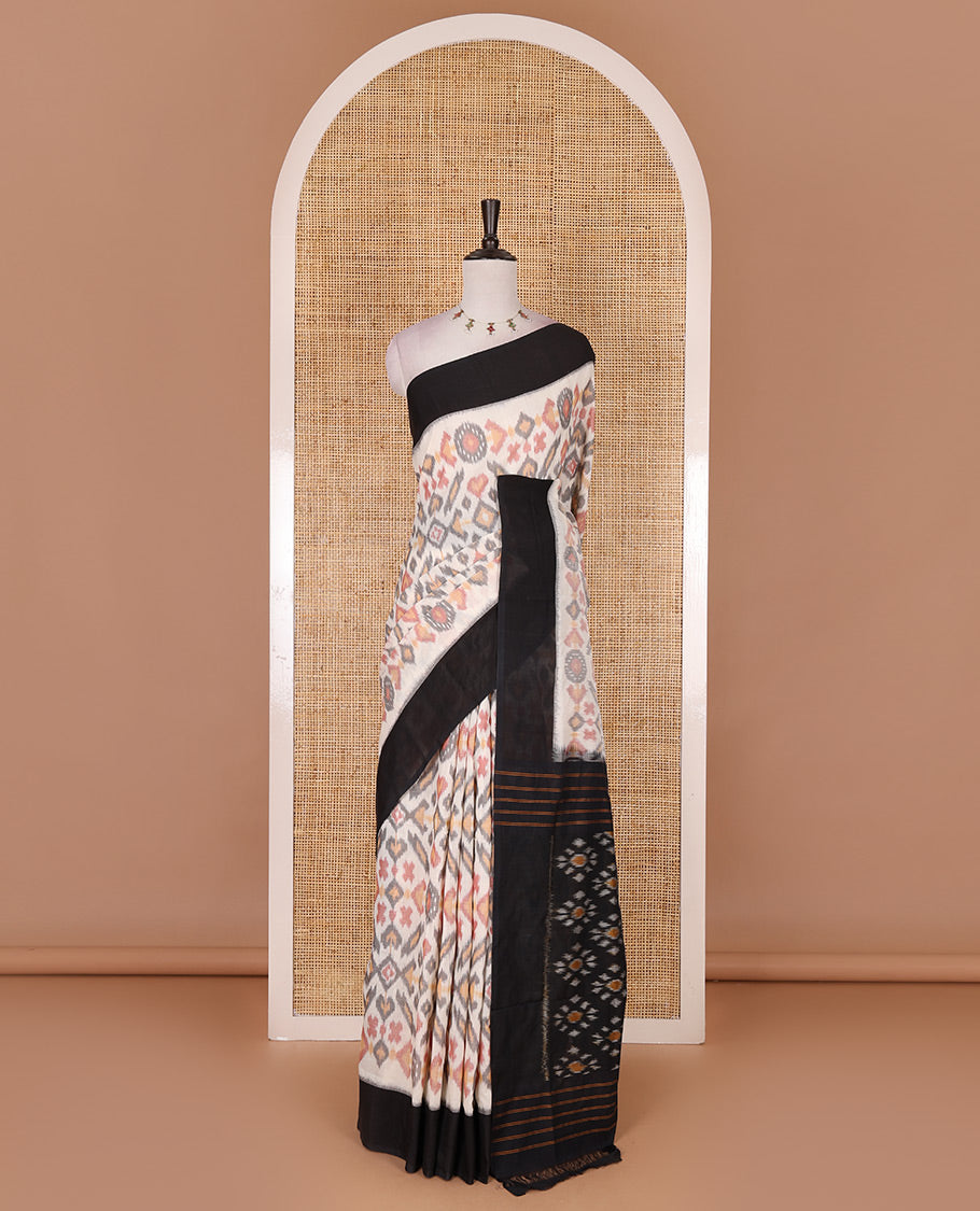 Half white intricate motifs featured ikkat cotton saree, contrast plain border, ikkat design pallu, and contrast plain blouse