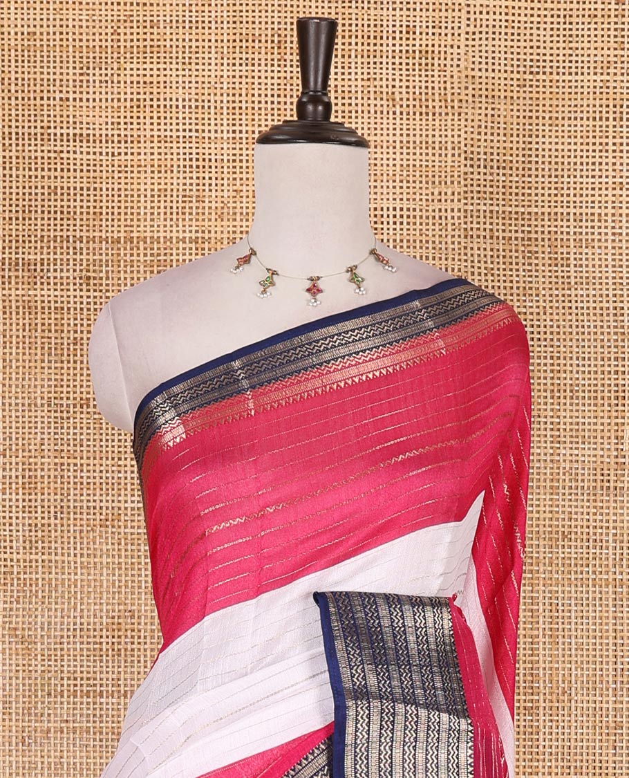 White zari design moss milan saree, contrast navy blue and pink colored traditional zari border, ikkat buttas printed pallu, and contrast zari design blouse