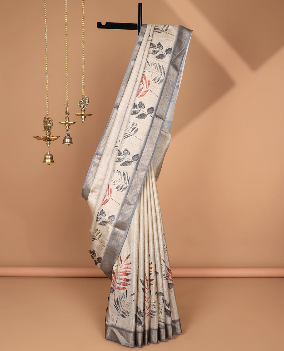Cream leaf print tussar saree with tissue border & crush tissue pallu along with crush leaf print blouse