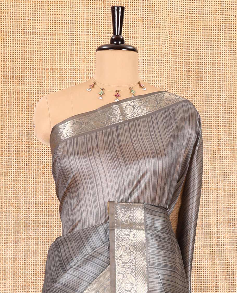 Grey striped semi-tussar saree, traditional zari border of floral creeper designs, contrast pallu of Pichwai cow print, and contrast Pichwai cow printed blouse