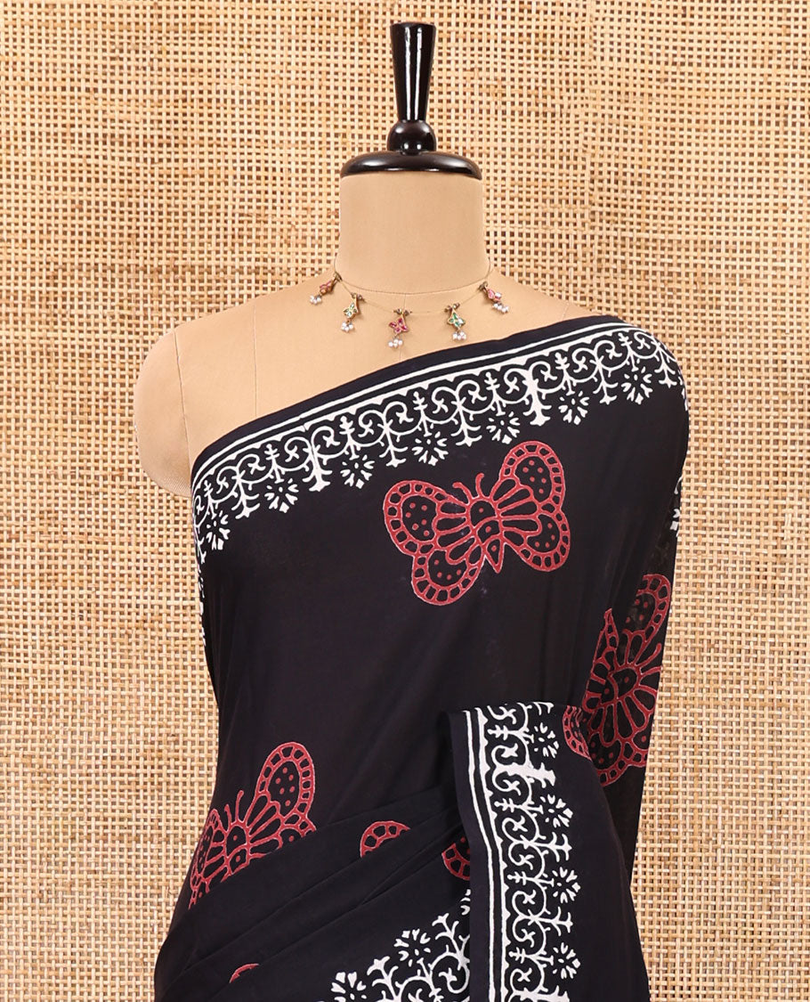 Black half-and-half style butterflies and warli theme block printed soft mul cotton saree, printed border, floral printed pallu, and a plain blouse