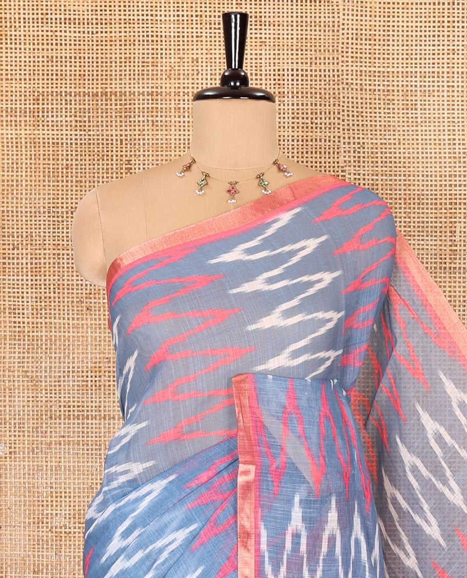 Borderless grey ikkat chevron patterned linen cotton saree, contrast zari piping border, ikkat buttas pallu, and a contrast ikkat buttas blouse