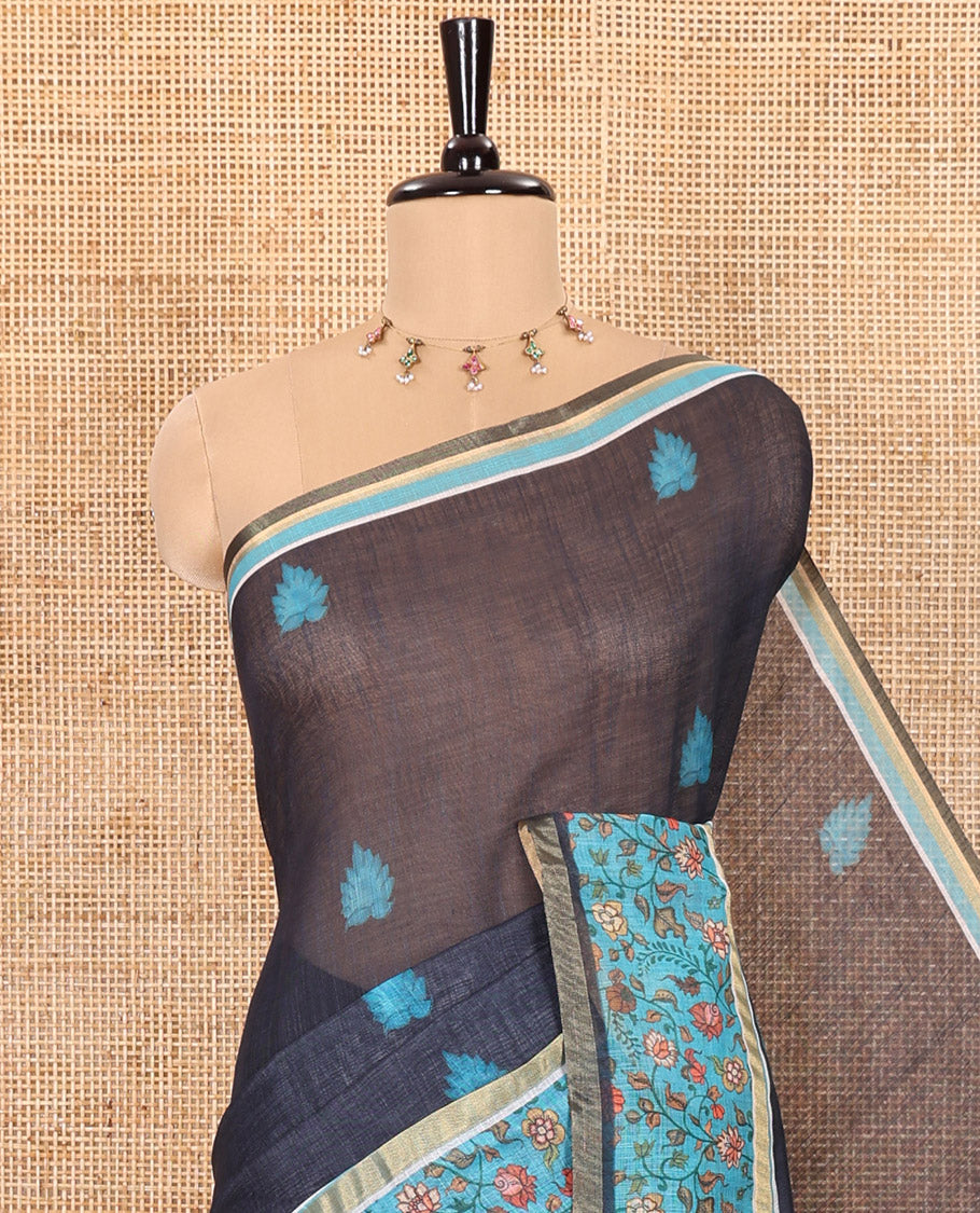 Blue Linen Saree Accentuated with Leaf Motifs All Over Its Body, Complemented by a Contrast Floral Vine Printed Border, Pallu Mirrors the Floral Vine Print, and Paired with a Contrast Floral Printed Blouse