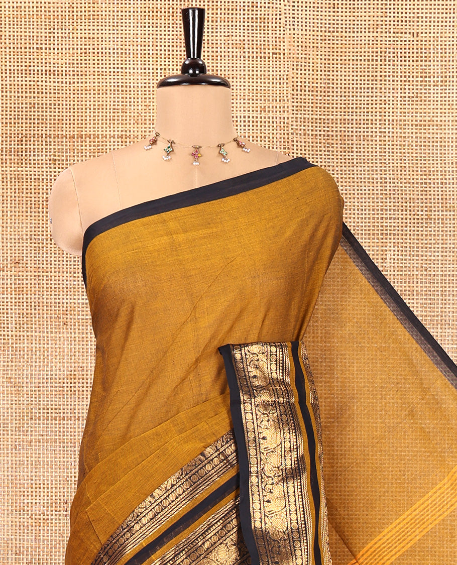 Mustard Plain Chettinad Cotton Saree, Complemented by a Contrast Rettai Pettu One-Sided Zari Border of Temple, Paisa, Elephant, and Peacock Designs, Subtly Striped Pallu, and Paired with a Matching Blouse