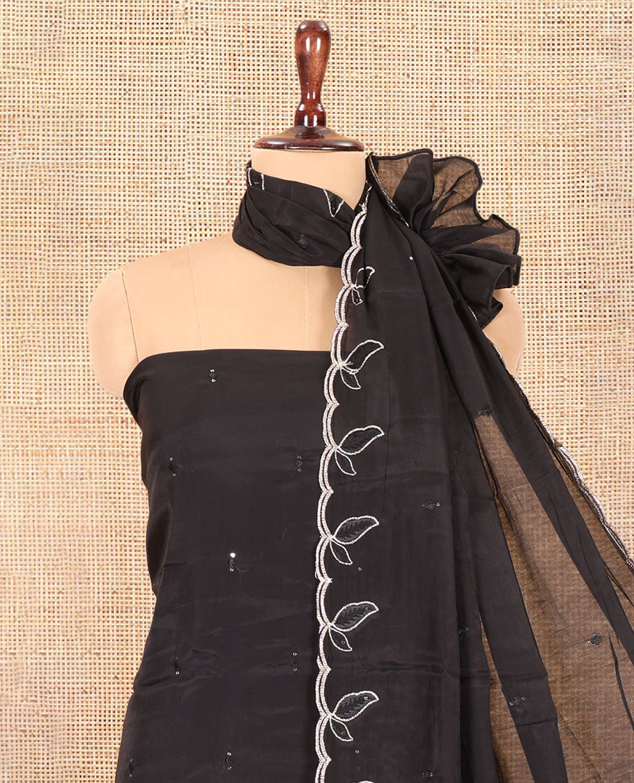 Black Mul Chanderi Material Churidar Features a Floral Outline Embroidered Top, a Santoon Bottom, a Scallop Threadwork Dupatta