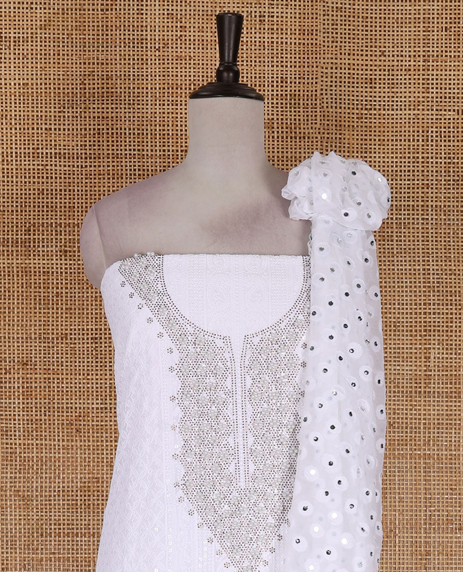 White material churidar set, stone work with Schiffli style embroidered georgette top, American Crape bottom, and polka dotted printed mirror work dupatta