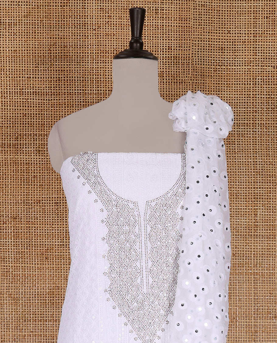 White material churidar set, stone work with Schiffli style embroidered georgette top, American Crape bottom, and polka dotted printed mirror work dupatta