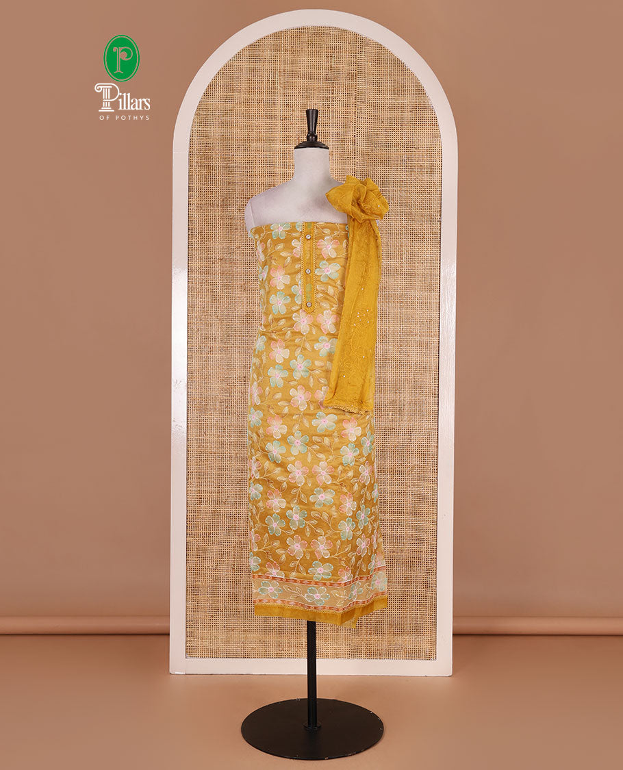 Mustard churidar material set, floral print with thread outlined organza top, plain santoon bottom, and floral vine sequins embroidered organza dupatta