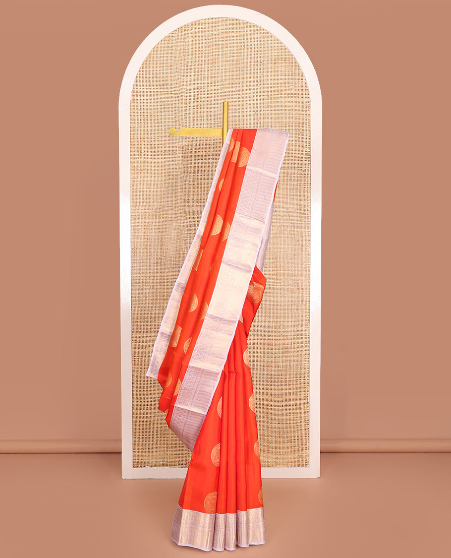 Orange Vasundhara Lite-Silk Mix Saree, Embellished with Chakram Zari Buttas All Over Its Body, Complemented by a Contrast Border of Rekku, Rudraksham, Neli, and Kathir Designs, Artfully Decked Up Pallu of Kathir Designs, and Paired with a Contrast Blouse