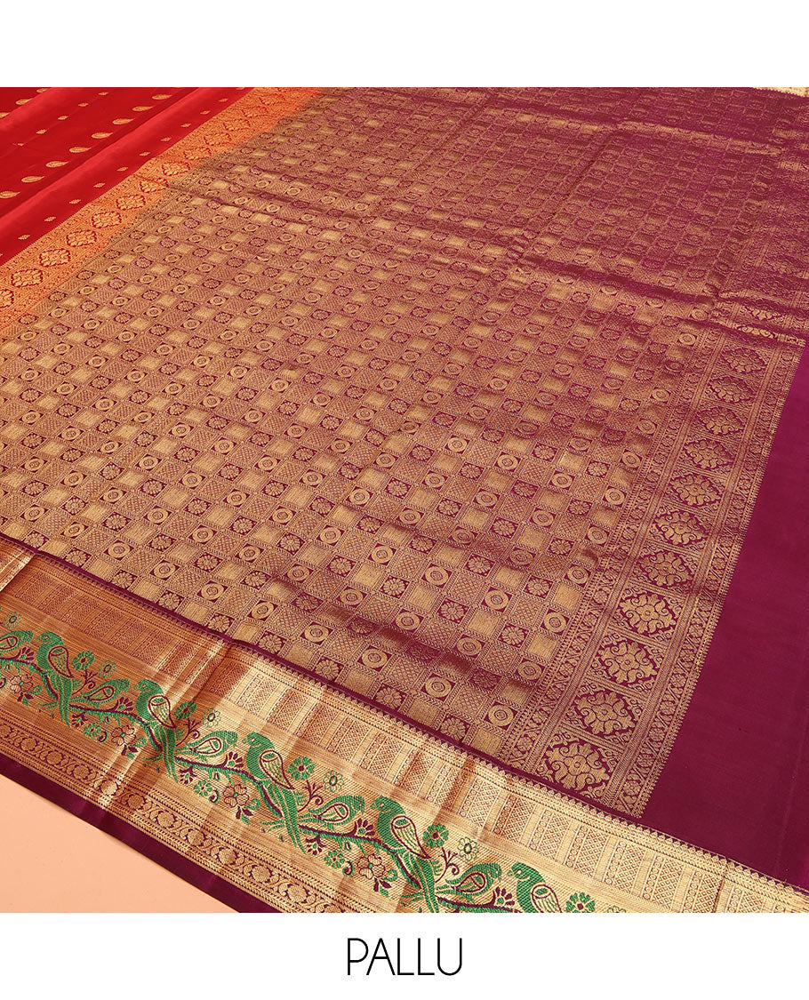 Orange Vasundhara Silk Mix Saree Decorated with Zari Buttas, Features Contrast Border Complemented with Thilakam, Banaras, Kathir, Mayil Kann, and Meenakari Parrot Motifs, a Pallu with Intricate Kanchi Motifs, Paired with a Contrast Blouse