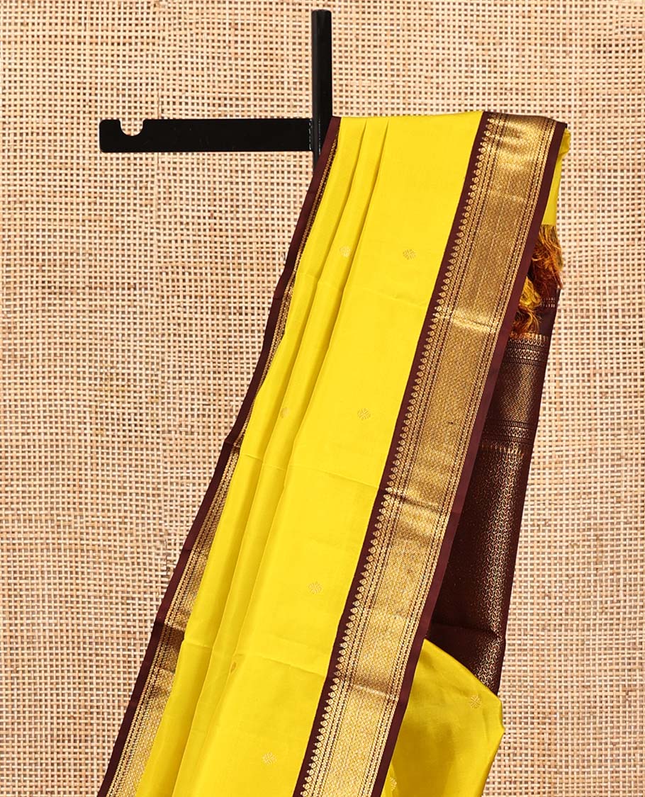 Yellow Vasundhara Silk Saree, Woven with Zari Buttas All Over Its Body, Complemented by a Contrast Korvai Border of Thilakam, Banaras, Neli, and Mayil Kann Designs, Grand Pallu, and Paired with a Contrast Blouse