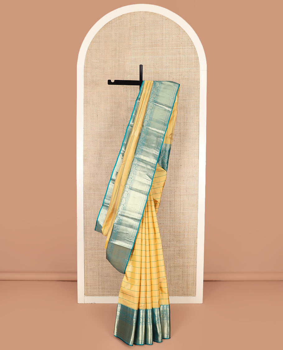 Yellow Vasundhara Silk Saree Graced with Stripes and Zari Buttas, Complemented by a Contrast Border of Thilakam Mokku, Vanki, Kathir, Lavangam, and Kodi Visiry Designs, Zari Elevated Pallu of Jaal Design, and Paired with a Contrast Blouse