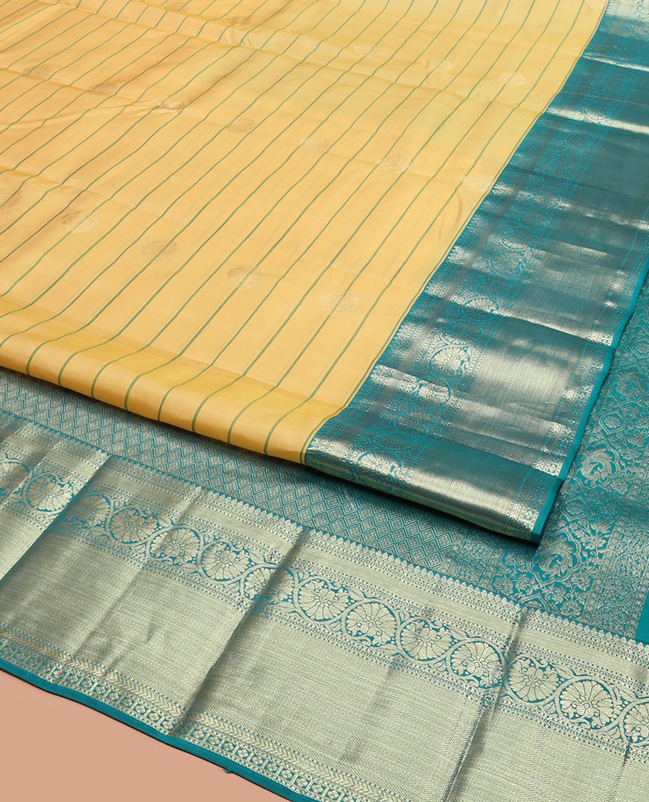 Yellow Vasundhara Silk Saree Graced with Stripes and Zari Buttas, Complemented by a Contrast Border of Thilakam Mokku, Vanki, Kathir, Lavangam, and Kodi Visiry Designs, Zari Elevated Pallu of Jaal Design, and Paired with a Contrast Blouse